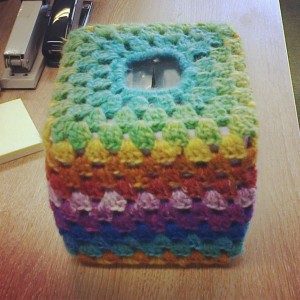 tissue box with rainbow striped cover